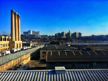 View of cityscape against clear blue sky