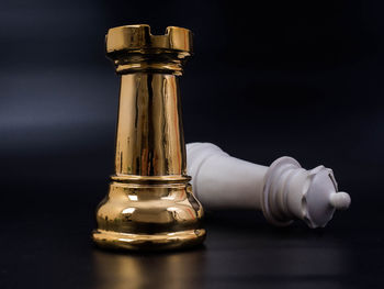 Close-up of bottle on table against black background