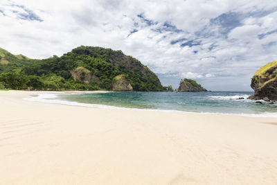 View of beach against cloudy sky