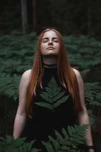 Woman meditating in forest