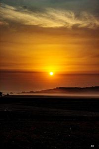 Scenic view of field against sky during sunset