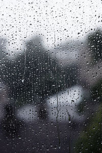 Full frame shot of wet glass window in rainy season