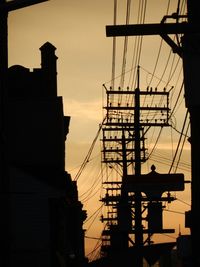 Low angle view of electricity pylon against sky