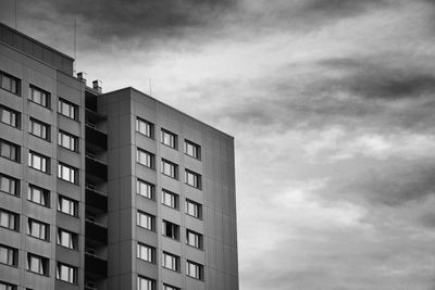 Modern building against cloudy sky