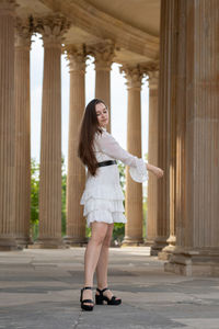 Full length of a young woman standing in corridor