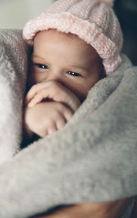 Close-up portrait of cute baby girl in snow