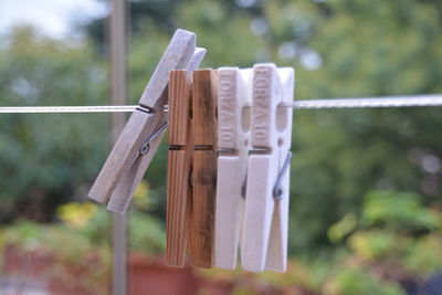 Close-up of pegs on washing line against blurred background