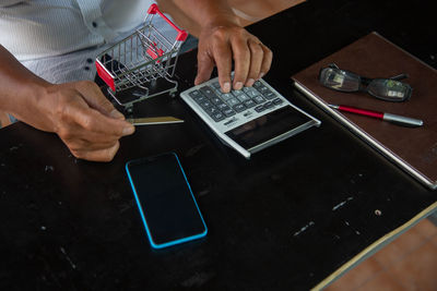 Midsection of man using mobile phone