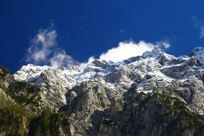 Scenic view of snow mountains against blue sky