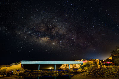 Illuminated building against sky at night