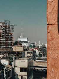 Buildings in city against clear sky