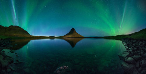 Scenic view of lake against sky at night