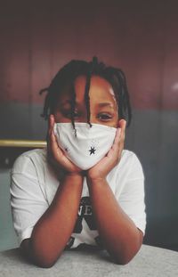 Portrait of young woman sitting at home