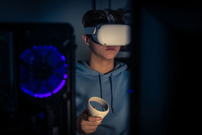 Teenager playing with virtual reality device. cyberpunk futuristic mood, video game and vr 3d viewer