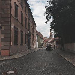 Street amidst buildings in city against sky