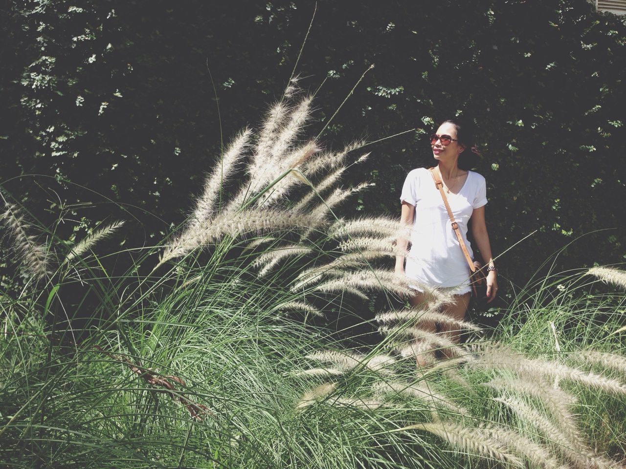 lifestyles, leisure activity, young adult, casual clothing, full length, person, young women, three quarter length, standing, plant, grass, growth, front view, field, outdoors, nature, day, tree