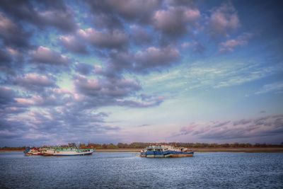 Boats sailing in sea against sky