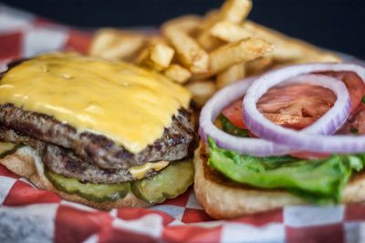 Close-up of hamburger and french fries in paper plate