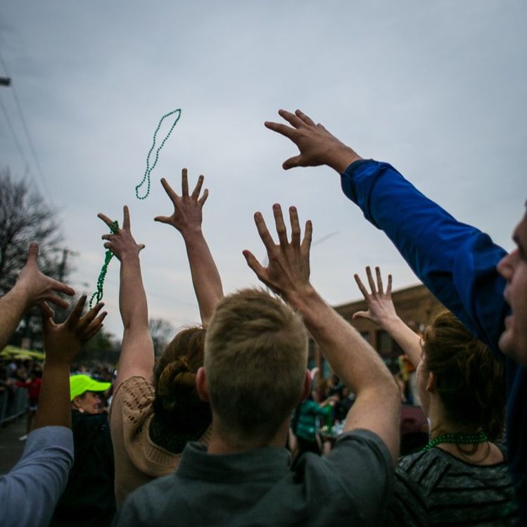 MAN WITH ARMS RAISED STANDING IN WATER