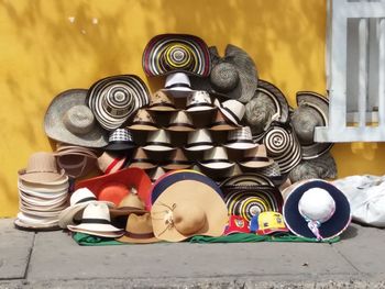 Multi colored hats for sale on sidewalk