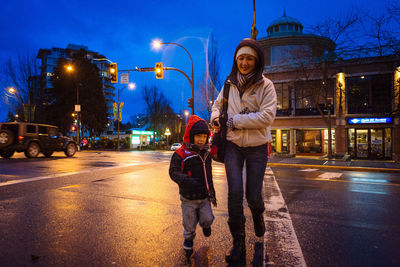 Woman standing on road at night