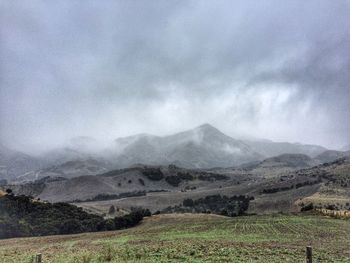 Scenic view of mountains against cloudy sky