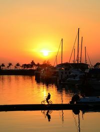 Boats at harbor during sunset