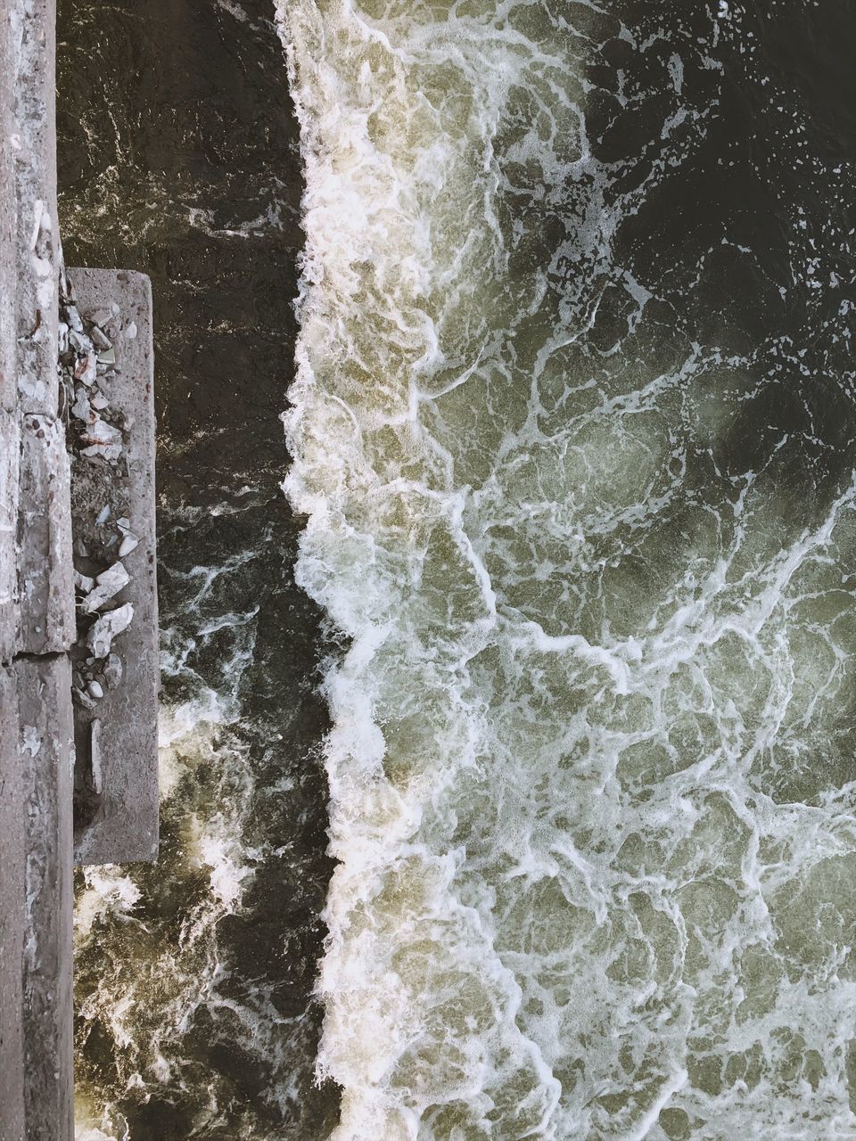 CLOSE-UP OF SEA BY WALL