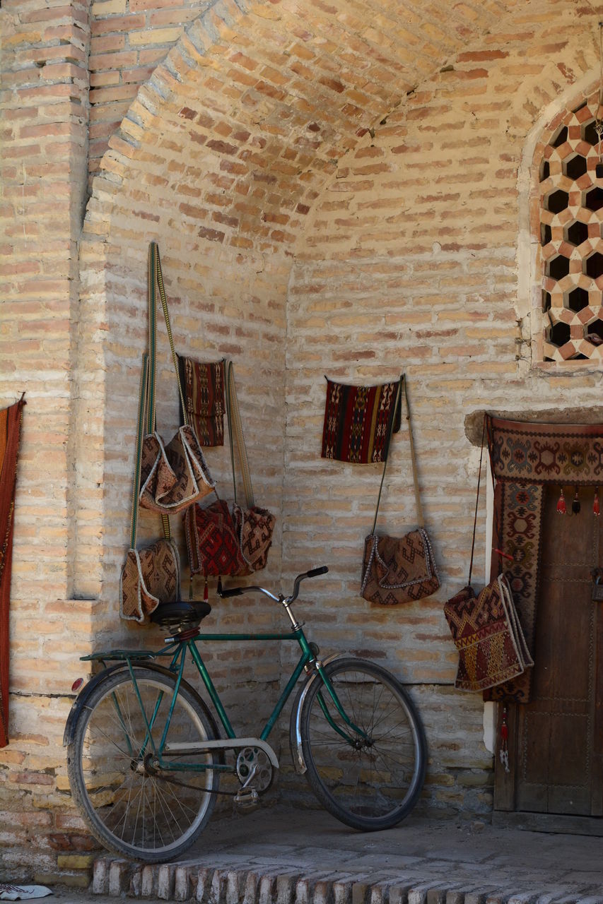 BICYCLE AGAINST BRICK WALL