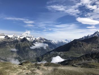 Scenic view of snowcapped mountains against sky