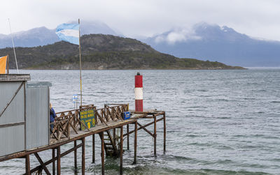 Scenic view of sea and mountains against sky