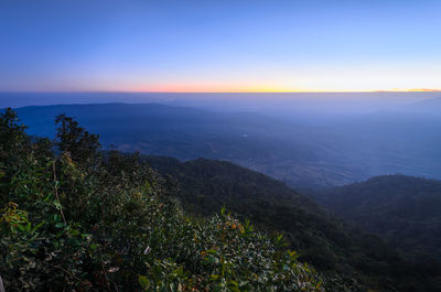 Scenic view of mountains against clear sky at sunset