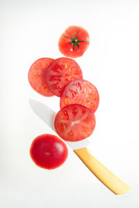 Slices of fresh tomato on a white background