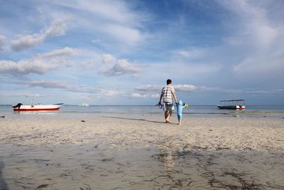 Father and child walking at beach