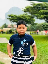 Portrait of boy standing on grass