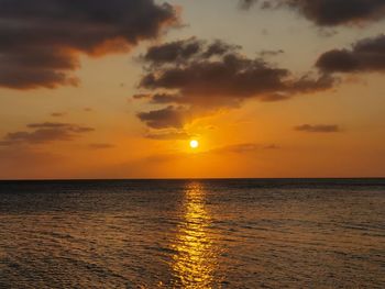 Scenic view of sea against romantic sky at sunset