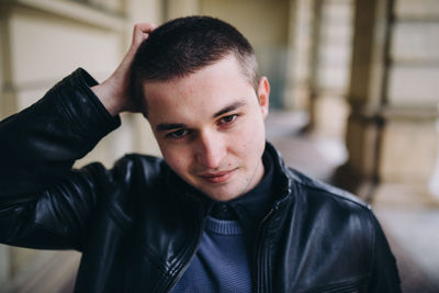 Portrait of young man standing in corridor of building