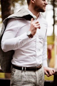 Midsection of man standing against wall