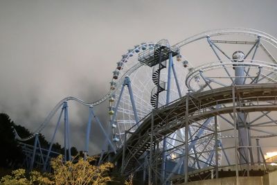 Low angle view of ferris wheel against sky