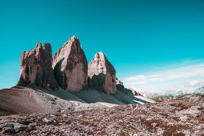 Panoramic view of rocks and mountain against blue sky