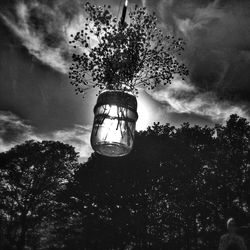 Low angle view of tree against cloudy sky