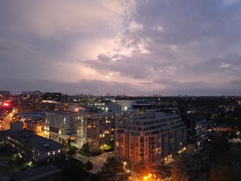 High angle view of illuminated buildings against sky at sunset