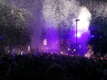 People enjoying music concert at night