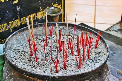 High angle view of incense sticks in container