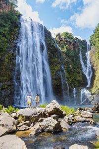 Scenic view of waterfall against sky