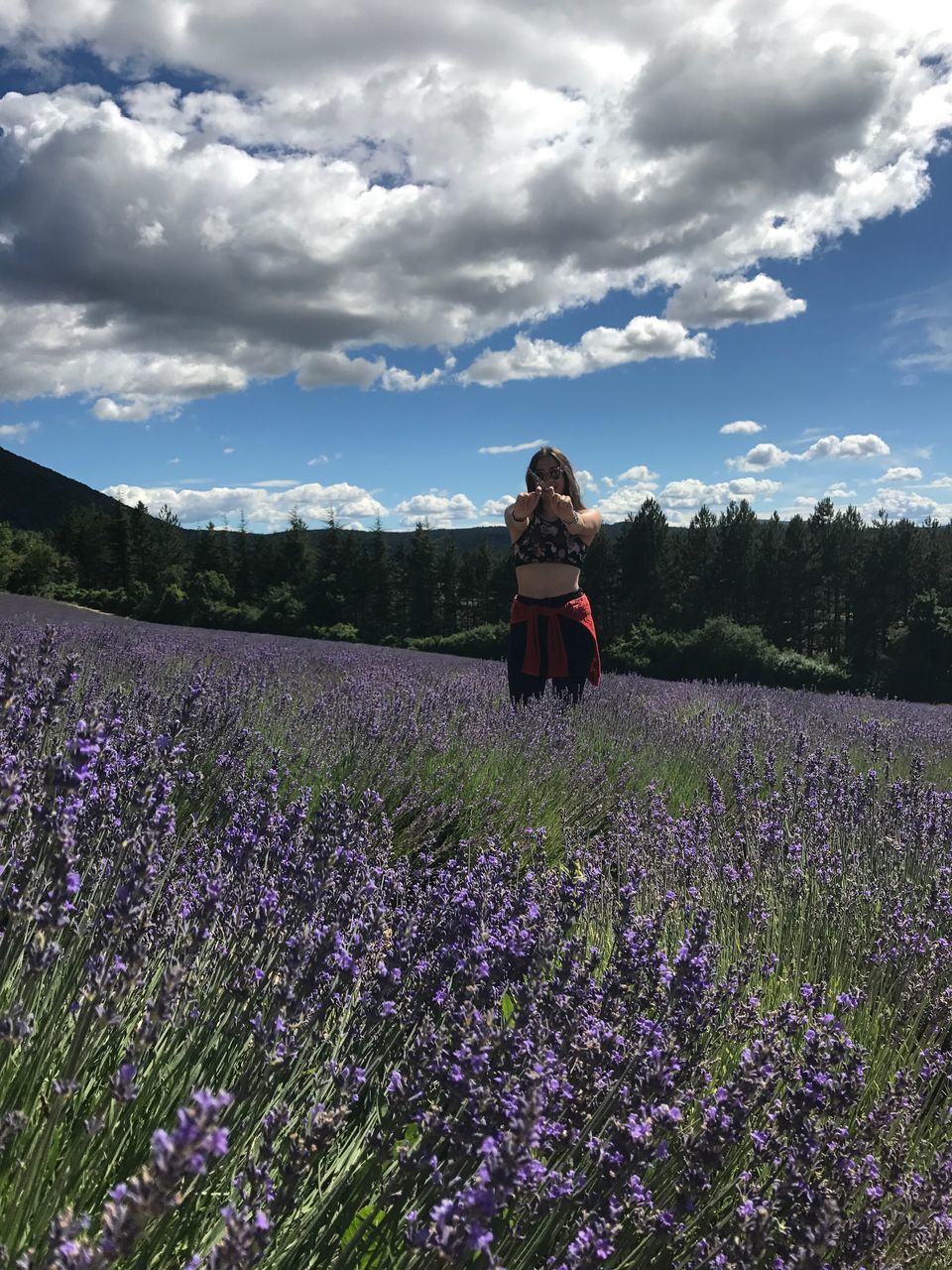flower, nature, field, real people, growth, purple, rear view, lavender, sky, cloud - sky, one person, beauty in nature, leisure activity, day, tranquility, tranquil scene, outdoors, lifestyles, plant, standing, agriculture, landscape, scenics, rural scene, women, young women, fragility, freshness, young adult, people