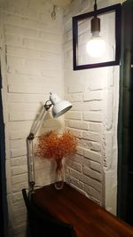 Illuminated lamp on wall at home