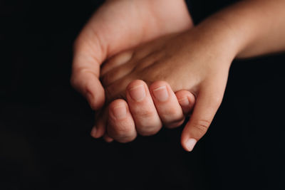 Cropped image of couple holding hands