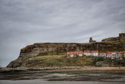 Buildings on mountain against sky