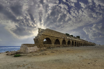 Ruins of an ancient aqueduct in caesarea.